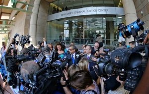 Surrounded by news media, special prosecutors Kent Schaffer center left, and Brian Wice, center right, speak after the morning court session in District Judge George Gallagher's court in Fort Worth, Texas, Thursday, Aug. 27, 2015. Texas Attorney Gen. Ken Paxton pleaded not guilty Thursday to charges alleging that he defrauded investors before he became the state's top lawyer. (Paul Moseley/Star-Telegram via AP) MAGS OUT; (FORT WORTH WEEKLY, 360 WEST); INTERNET OUT; MANDATORY CREDIT