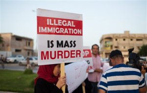 In this Thursday, Aug. 27, 2015 photo, local residents hold a demonstration against illegal immigration after hearing news that a boat carrying hundreds of migrants capsized off the coast, in Zuwara, Libya. It was not clear how many migrants had drowned. Dozens of boats are launched from lawless Libya each week, with Italy and Greece bearing the brunt of the surge. (AP Photo/Mohamed Ben Khalifa)