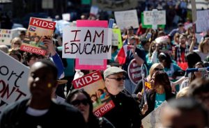 FILE - In this Feb. 23, 2013 file photo, teachers, students, parents and school administrators march up Congress Avenue to the state Capitol, in Austin, Texas to a rally for Texas public schools. Ninth-graders who were barely a month into high school when Texas latest school finance trial began in 2012 are now entering their senior year. Theres no end in sight for the case, in which oral arguments begin Tuesday in front of the state Supreme Court. (AP Photo/Eric Gay, File)