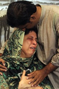 Pakistani mother, Sarwari Begum, is comforted by her husband, as she cries for her daughter, Bushra Khalique, 27, who is reportedly missing after a crush during the hajj pilgrimage in Saudi Arabia, Saturday, Sept. 26, 2015 in Karachi, Pakistan. As the hajj religious pilgrimage entered its final day Saturday, officials in Saudi Arabia continued to grapple with the aftermath of a deadly stampede that killed at least 750 people. (AP Photo/Fareed Khan)