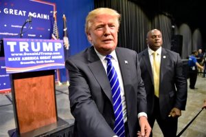 FILE - In this Aug. 27, 2015 file photo, Republican presidential candidate Donald Trump greets supporters after speaking at a rally at the TD Convention Center in Greenville, S.C. NBC announced Tuesday, Sept. 1, that Trump will sit down with host Jimmy Fallon to discuss his campaign and other issues on "The Tonight Show Starring Jimmy Fallon," on Sept. 11. (AP Photo/Richard Shiro, File)