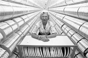 FILE- In this Aug. 12, 1985, file photo, Lillie Steinhorn, 74, stands inside the computer tape storage room at the headquarters of the Social Security Administration in Baltimore. She began work for the agency in 1936, a year after the Social Security Act was signed into law. As Social Security approaches its 80th birthday on Aug. 14, 2015, the federal government's largest benefit program faces serious financial problems that could be fixed with only modest changes, if Congress acts quickly. (AP Photo/Bill Smith, File)
