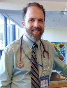 In this Wednesday, Sept. 23, 2015 photo, Dr. Richard Sacra poses for a photo at the Family Health Center in downtown Worcester, Mass., where he advises doctors in training. Sacra contracted the deadly Ebola virus while delivering babies in a missionary-run hospital in Liberia a year earlier. He was the first of Americas handful of Ebola survivors to return to West Africa last January. He also went in April and July to work at a hospital outside Monrovia, Liberias capital, and plans to return in November. (AP Photo/Philip Marcelo)
