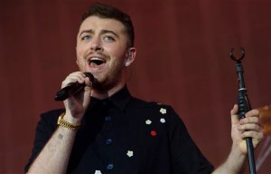 FILE - This is a Saturday, Aug. 22, 2015 file photo of British singer Sam Smith as he performs on stage during the V Festival 2015 at Hylands Park in Chelmsford, Essex, England. The choice was shrouded in mystery and denials, but British singing sensation Sam Smith has surfaced as the singer of the theme song for the new James Bond film, Spectre. He had denied the rumors, but came clean Tuesday, Sept. 8, 2015, tweeting that taking part in the Bond film was a high point in his remarkable, multiple-award winning career. (Photo by Jonathan Short/Invision/AP, File)