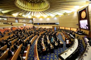 Thailand's legislature, known as the National Reform Council, stands after they votee 135 against vs. 105 in favor with seven abstentions on the new draft constitution Sunday, Sept. 6, 2015, in Bangkok, Thailand. Thailand's military-backed legislature on Sunday rejected an unpopular draft of a new constitution, delaying a return to democracy following a coup last year. (AP Photo/Wason Wanichakorn)