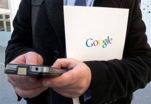 FILE - In this Dec.10 2013 file photo, a reporter uses his phone during a presentation for the new Google cultural institute in Paris,  France. France's data privacy regulator has rejected Monday Sept.21, 2015 Google's appeal of an order to remove search results worldwide upon request. (AP Photo/Jacques Brinon, File)