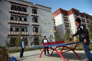 In this Friday, Sept. 18, 2015 photo, students play ping-pong outside of the Lhasa-Beijing Experimental Middle School in Lhasa, capital of the Tibet Autonomous Region of China. Top-down development has poured more than $100 billion dollars into the region since 1952, but critics say that Beijings obsession with social stability also has led to widespread human right abuses. (AP Photo/Aritz Parra)