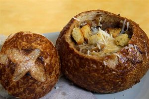 FILE - This June 9, 2015, file photo, shows a Bistro French Onion Soup Bread Bowl at a Panera bread restaurant in New York. The city Board of Health voted unanimously Wednesday, Sept. 9 to require chain eateries to put salt-shaker symbols on menus to denote dishes with more than the recommended daily limit of 2,300 milligrams of sodium. A Bistro French Onion Soup Bread Bowl contains more sodium than the recommended daily limit, which is equal to about 1 teaspoon of salt. (AP Photo/Mary Altaffer, File)