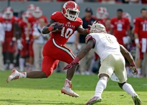 FILE - In this Sept. 27, 2014, file photo, Florida State's Tyler Hunter (1) looks to tackle North Carolina State's Shadrach Thornton (10) during the first half of an NCAA college football game in Raleigh, N.C. Thornton is eligible to return Saturday against Old Dominion after being suspended for the first two games.  (AP Photo/Gerry Broome, File)