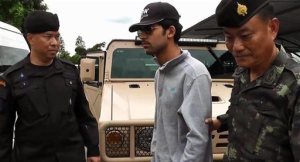 In this image provided by the National Council for Peace and Order (NCPO) Thai authorities arrest a man they believe is part of a group responsible for a deadly bombing at a shrine in central Bangkok on Aug. 17, 2015. Prime Minister Prayuth Chan-ocha told reporters on Tuesday, Sept. 1, 2015, that the man is a foreigner and was detained in eastern Thailand near the Cambodian border, one of several border crossings where authorities set up checkpoints after the bombing which killed 20 people, many of them foreign tourists, and injured more than 120. (National Council for Peace and Order via AP)