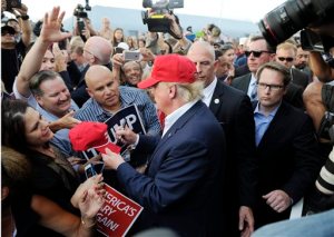 Republican presidential candidate Donald Trump, center, greets supporter after speaking at a campaign event aboard the USS Iowa battleship in Los Angeles Tuesday, Sept. 15, 2015. (AP Photo/Kevork Djansezian)