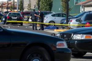 Police officers stand near the body of a victim killed in a shooting at Sacramento City College, Thursday, Sept. 3, 2015, in Sacramento, Calif. The shooting occurred in a parking lot near the baseball field on the college campus. (Renée C. Byer/The Sacramento Bee via AP)  MAGS OUT; LOCAL TELEVISION OUT (KCRA3, KXTV10, KOVR13, KUVS19, KMAZ31, KTXL40); MANDATORY CREDIT