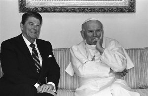 FILE - In this May 2, 1984 file photo, Pope John Paul II strike a pensive pose as he and President Ronald Reagan sit for photographers prior to having a private meeting in Fairbanks, Alaska at the airport.    After the meeting Reagan left for Washington and the pope for South Korea. (AP Photo/Scott Stewart)