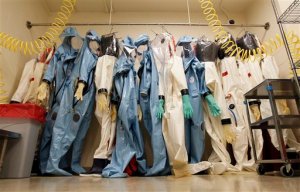 FILE - In this Aug. 10, 2011, file photo, biohazard suits hang in a Biosafety Level 4 laboratory at the U.S. Army Medical Research Institute of Infectious Diseases at Fort Detrick, Md. Army Secretary John McHugh on Spet. 3, 2015, has suspended operations at four Defense Department laboratories, including at USAMRIID, that handle biological toxins, as the military scrambles to explain and correct problems that led to the accidental shipment of live anthrax to dozens of other labs around the country and the world. (AP Photo/Patrick Semansky)