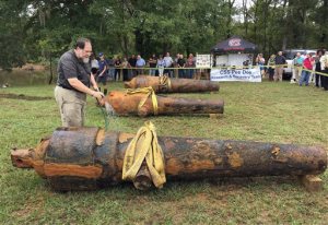 In this photo provided by the University of South Carolina, University of South Carolina archaeologist and state archaeologist Jon Leader washes and inspects one of the three Civil War cannons pulled from the Pee Dee River on Tuesday, Sept. 29, 2015, in Mars Bluff, S.C. The three cannons were dumped in the river by Confederate forces from the gunboat CSS Pee Dee in 1865 in order to keep them from falling into the hands of Union forces. (Margaret "Peggy" Ryan Binette/University of South Carolina via AP)