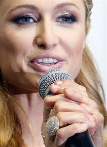 FILE--In this Aug. 28, 2015 file photo Paris Hilton wears her diamond-studded ring as she speaks to the press during a fashion show in Lodz, Poland, Friday, Aug. 28, 2015.The 34-year-old socialite lost the enormous ring on a shuttle bus on her way to the Lodz airport and two days later a fireman who works at the airport found it on the floor of the bus. (AP Photo/Czarek Sokolowski, file)