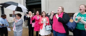 FILE - In a Thursday, June 4, 2015 file photo, Sweet Briar College alumni do a cheer for the school after a hearing on the closure of Sweet Briar college at the Supreme Court of Virginia in Richmond, Va. Sweet Briar President Phillip C. Stone marvels at the energy of passionate alumnae who helped save the school just a few months ago from closure. But he knows without a serious change in fortune, the salvation will only be temporary. (AP Photo/Steve Helber, File)