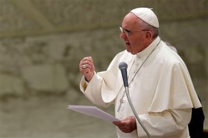 Pope Francis delivers his message during an audience with faithful and employees of the Rome's Cooperative Credit Bank in the Paul VI hall at the Vatican, Saturday, Sept. 12, 2015. To some Republican presidential candidates, its better to be with the popular pope than against him. (AP Photo/Gregorio Borgia)