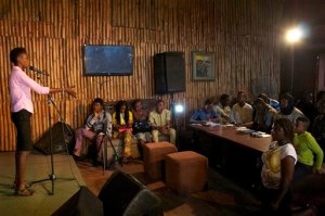 In this photo taken Sunday, Aug. 16, 2015, a woman competes in a slam poetry competition in Lagos, Nigeria. Nigeria's young poets hurled words against the injustices plaguing the giant of Africa, from corruption to Boko Haram's insurgency, in the fifth "War of Words" poetry slam. (AP Photo/Caelainn Hogan)