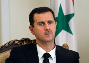 FILE - This Aug. 19, 2009 file photo shows Syrian President Bashar Assad during a meeting with his Iranian counterpart Mahmoud Ahmadinejad in Tehran, Iran. Speaking in an interview with Russian media, Tuesday, Sept. 15, 2015, Assad said the refugee crisis now hitting Europe is a direct result of the West's support of "terrorists" in Syria. The Russian president has said it is impossible to defeat the Islamic State group without cooperating with Damascus, and in recent days has sent about a half-dozen battle tanks and other weaponry to Syria. (AP Photo/Vahid Salemi, File)