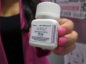 FILE - In this Aug. 18, 2015 file photo, Sprout Pharmaceuticals CEO Cindy Whitehead holds a bottle for the female sex-drive drug Addyi at her Raleigh, N.C. Valeant Pharmaceuticals will pay about $1 billion to buy Sprout Pharmaceuticals. The deal Thursday, Aug. 20, 2015, comes one day after regulators approved Addyi. Valeant expects the Sprout pill, Addyi, to be available in the United States in the fourth quarter. (AP Photo/Allen G. Breed)