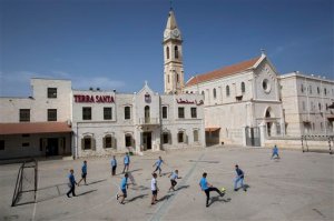 FILE - In this Tuesday, May 26, 2015 file photo, Arab Israeli Christian school children play soccer at the Terra Santa School in the mixed Jewish-Arab city of Ramle, Israel. The Israeli school year has begun, but thousands of children from the Arab minority who attend Christian schools are still on summer vacation because of a strike to protest cuts in government funding that critics say amount to discrimination.(AP Photo/Oded Balilty, File)
