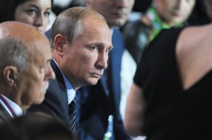 Russian President Vladimir Putin, center, listens to a question during a meeting with his supporters in Moscow, Russia, Monday, Sept.  7, 2015 Putin took part in a discussion on Monday of a health care reform with his supporters who form All-Russian Peoples Front. (Mikhail Klimentyev/RIA-Novosti, Kremlin Pool Photo via AP)