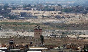 FILE - In this July 2, 2015 file photo, an Egyptian armored vehicle patrols next to a military watch tower on the Egyptian side of the border, seen from the south of the Gaza Strip. The Obama administration is quietly reviewing the future of America's three-decade deployment to the Sinai Peninsula, fearful the lightly equipped peacekeepers could be targets of escalating Islamic State-inspired violence. Options include beefing up their protection or pulling them out altogether. (AP Photo/Adel Hana, File)