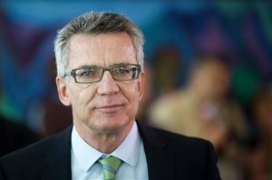 FILE - In a Wednesday, Sept. 2, 2015 file photo, German Interior Minister Thomas de Maiziere arrives for the weekly cabinet meeting of German government at the chancellery in Berlin. De Maiziere said Sunday, Sept. 13, 2015, that Germany is introducing temporary border checks on the Austrian frontier in a bid to limit the influx of refugees. The move, de Maiziere said, was also a signal to Europe: Germany is facing up to its humanitarian responsibility, but the burdens connected with the large number of refugees must be distributed in solidarity within Europe.  (AP Photo/Markus Schreiber, File)