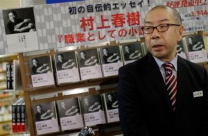 Toru Nishine, shop manager of Kinokuniya Bookstore, speaks to journalists in front of Japanese novelist Haruki Murakami's new Japanese-language book, Novelist as a Vocation, on sale in Tokyo Thursday, Sept. 10, 2015. For best-selling Japanese novelist Murakami, finding a market for his books seems an unlikely problem. His latest work, released Thursday was 90 percent spoken for weeks ago, when major book seller Kinokuniya ordered 90,000 out of the 100,000 copies of the first printing. (AP Photo/Eugene Hoshiko)