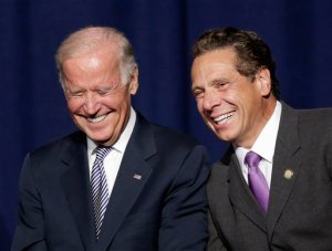 Vice President Joe Biden and New York Gov. Andrew Cuomo laugh prior to speaking at a labor rally, Thursday, Sept. 10, 2015, in New York. Cuomo is proposing to raise the state minimum wage to $15 an hour. (AP Photo/Mark Lennihan)