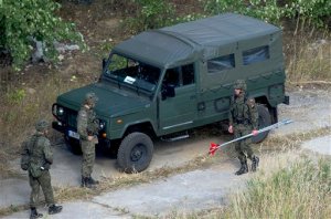 Polish military experts arrive at a spot in in southwestern Poland where a Nazi train missing since World War II could be located in Walbrzych, Poland, on Monday Sept. 28, 2015. Chemical, radiation and explosives experts are checking the site to exclude any danger for local residents. The work is scheduled to run from Monday through Saturday. (AP Photo/Natalia Dobryszycka)