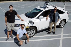 In this Monday, Aug. 24, 2015 photo, Brian Torcellini, Google team leader of driving operations, right, poses for photos with vehicle safety specialists Rob Miller, top left, and Ryan Espinosa, next to a vehicle at a Google office in Mountain View, Calif. Google employs a few dozen "safety drivers that grab the steering wheel or hit the brakes on a fleet of robot cars that Googles engineers are programming to navigate the roads without human assistance. (AP Photo/Jeff Chiu)