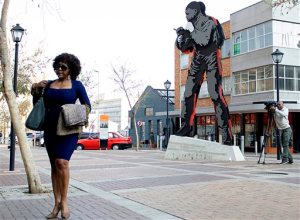 Ndileka Mandela, eldest granddaughter of former President Nelson Mandela, statue back, arrives at the Johannesburg Magistrates Court, Tuesday, Aug. 25, 2015 in support of a 25-year-old grandson of the former statesman who is accused of raping a minor at a Johannesburg bar. (AP Photo/Shiraaz Mohamed)