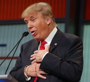 FILE - In this Aug. 6, 2015, file photo, Republican presidential candidate Donald Trump responds to former Arkansas Gov. Mike Huckabee's closing remarks during the first Republican presidential debate at the Quicken Loans Arena in Cleveland. Lobbing rhetorical stink bombs at a large group of voters is not the normal way to get ahead in U.S. politics. Nor is alienating prominent figures of your own party. But Trump has turned the dos and donts of campaigns on their head, prospering with tactics that could sink anyone else. (AP Photo/Andrew Harnik, File)