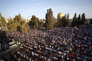 Palestinian pray during the Muslim holiday of Eid al-Adha, near the Dome of the Rock Mosque in the Al Aqsa Mosque compound in Jerusalem's old city, Thursday, Sept. 24, 2015. Muslims will slaughter cattle and goats later, with the beef and meat distributed to the needy in the holiday which honors the prophet Abraham for preparing to sacrifice his son on the order of God, who was testing his faith. (AP Photo/Mahmoud Illean)