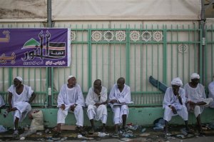 Muslim pilgrims sit by the site where pilgrims were crushed and trampled to death during the annual hajj pilgrimage in Mina, Saudi Arabia, Thursday, Sept. 24, 2015. The crush killed hundreds of pilgrims and injured hundreds more in Mina, a large valley on the outskirts of the holy city of Mecca, the deadliest tragedy to strike the pilgrimage in more than two decades. (AP Photo/Mosa'ab Elshamy)