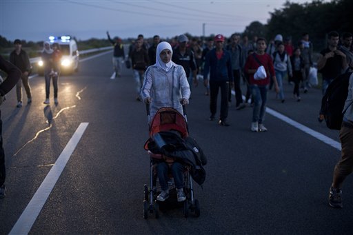 Hundreds surge past police near Hungary border, march&nbsp;north