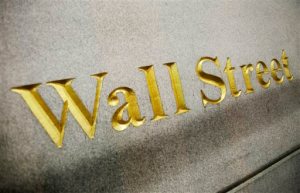 FILE - This Oct. 8. 2014 photo shows a Wall Street address carved into the side of a building in New York. Japanese stocks posted their biggest gain in nearly seven years Wednesday, Sept. 9, 2015, leading other world indexes higher, as Asian officials sought to counter pessimism about prospects for markets and economic growth. (AP Photo/Mark Lennihan, File)