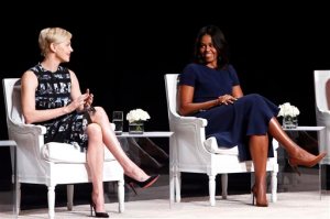 Actress Charlize Theron, left, applauds first lady Michelle Obama during a panel discussion entitled The Power of an Educated Girl at the Apollo Theater, Tuesday, Sept. 29, 2015, in New York. (AP Photo/Jason DeCrow)
