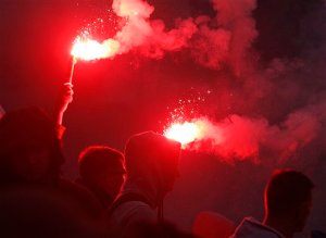 Several thousand right wing nationalists burn flares as they march through the downtown, demonstrating against EU proposed quotas for Poland to spread the human tide of refugees around the Europe, in Warsaw, Poland, Saturday, Sept. 12, 2015. (AP Photo/Czarek Sokolowski)