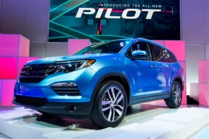 FILE - In this Feb. 12, 2015 file photo, the 2016 Honda Pilot is unveiled during the media preview of the Chicago Auto Show at McCormick Place in Chicago. Revamped from roof to tires, the Pilot for 2016 lost its boxy exterior styling and has a much more upscale interior, more features and more power_ now 280 horsepower from a re-engineered and noticeably refined V-6. (AP Photo/Andrew A. Nelles, File)