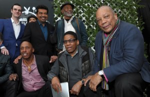 FILE - In this Feb. 28, 2013 file photo, Quincy Jones, right, poses with participants in this year's Playboy Jazz Festival, clockwise from top left, Playboy Enterprises founder Hugh Hefner's son Cooper, master of ceremonies George Lopez, and musicians Hubert Laws, Herbie Hancock and Jeffrey Osborne, following a news conference at the Playboy Mansion in Los Angeles. The new book "Playboy Swings" releasing on Sept. 14, 2015, details Hugh Hefner's contribution to popularizing jazz and his stand against racial segregation in entertainment. (Photo by Chris Pizzello/Invision/AP, File)