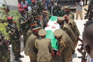 Army officers carry the casket of Lt. Gen. Adolphe Nshimirimana, during his funeral in Bujumbura, Burundi, Saturday, Aug. 22, 2015. Government officials, relatives and friends on Saturday attended an emotional funeral service for Lt. Gen. Adolphe Nshimirimana, the former intelligence chief and key ally of the president who was assassinated earlier this month in the Burundian capital of Bujumbura. (AP Photo/Berthier Mugiraneza)