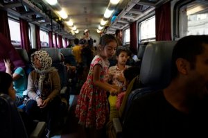 Migrants are seen on a train bound for Sopron, 208 kms west from Budapest at the Keleti Railway Station in Budapest, Hungary, Thursday, September 3, 2015. Migrants are now allowed to enter the station but direct trains from Budapest to Western Europe are currently out of operation until further notice. (Zoltan Balogh/MTI via AP)