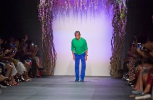 Fashion designer Tadashi Shoji bows to audience applause after showing his Spring 2016 collection, during Fashion Week on Thursday, Sept. 10, 2015, in New York. (AP Photo/Bebeto Matthews)