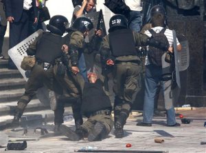 Police officers carry their injured colleague after grenade exploded during a clash between protesters and police after vote to give greater powers to the east, outside the Parliament, Kiev, Ukraine, Monday, Aug. 31, 2015. The Ukrainian parliament has given preliminary approval to a controversial constitutional amendment that would provide greater powers to separatist regions in the east. Hundreds of people gathered in front of the parliament to protest against the amendment. (AP Photo/Vladimir Donsov)