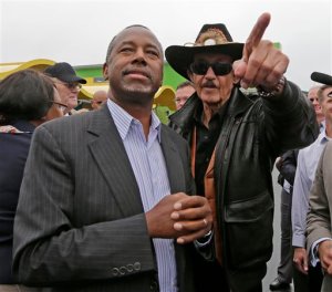 Republican presidential candidate, retired neurosurgeon Ben Carson listen as NASCAR legend Richard Petty gives him a tour of the Victory Junction Gang Camp in Randleman, N.C., Monday, Sept. 28, 2015. (AP Photo/Chuck Burton)