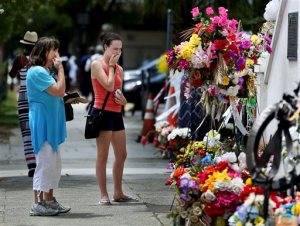 ADVANCE FOR USE MONDAY, SEPT. 7 - In this photo taken Aug. 4, 2015, Lyn Akers, left, with her grand daughter Caryl Lyn Akers shed tears as they visit Emanuel AME Church in Charleston, S.C, for the first time since the June 17 shooting deaths of nine parishioners. The family has visited nearby Seabrook for the last eight years from Kentucky. (Grace Beahm/The Post And Courier via AP) MANDATORY CREDIT
