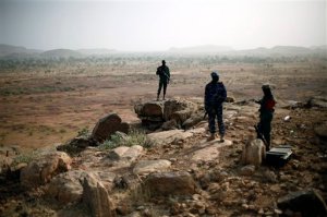 FILE - In this Thursday, Jan. 24, 2013 file photo, Malian troops man an observation post outside Sevare, some 620 kms (385 miles) north of Mali's capital Bamako. Four people held by Islamic extremists in a hotel in Sevare in central Mali were freed Saturday, Aug. 8, 2015 by the army and special forces, after fighting since Friday left a number of dead, Mali's defense ministry adviser said. (AP Photo/Jerome Delay, File)